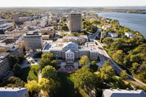 Bascom Hall, Bascom Hill and the central University of Wisconsin-Madison campus are pictured in an aerial view during autumn on Oct. 12, 2013. Clockwise from the left, major campus facilities include South Hall, Birge Hall, Van Vleck Hall, Van Hise Hall, Carillon Tower and North Hall. In the background at right is Lake Mendota. The photograph was made from a helicopter looking west. (Photo by Jeff Miller/UW-Madison)