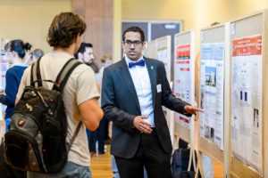 Faisal Bin Salem (right) presents his research project to attendees at the Undergraduate Research Symposium hosted in Varsity Hall at Union South at the University of Wisconsin-Madison on April 14, 2016. The annual event showcases student-led research, creative endeavors and service-learning projects. (Photo by Bryce Richter / UW-Madison)