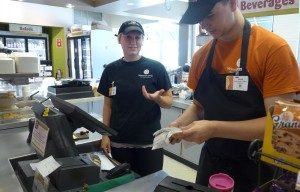 Student cashiers at Ingraham deli sort a stack of unwanted receipts.