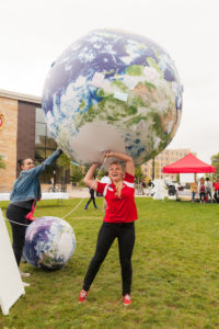 Photo of Bre Nehls with an inflatable earth