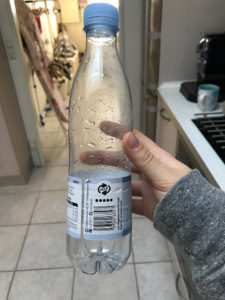 Bottle with returnable information printed on the label. 
