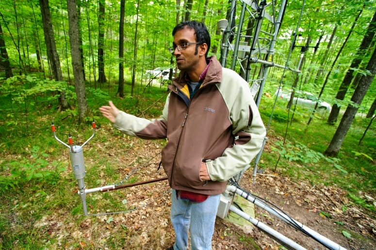 Ankur Desai stands in front of a 27-meter-tall flux tower in 2011. PHOTO: BRYCE RICHTER