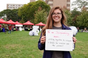 Office of Sustainability intern Hannah Kasun with her definition of sustainability. Photo by Office of Sustainability intern team.