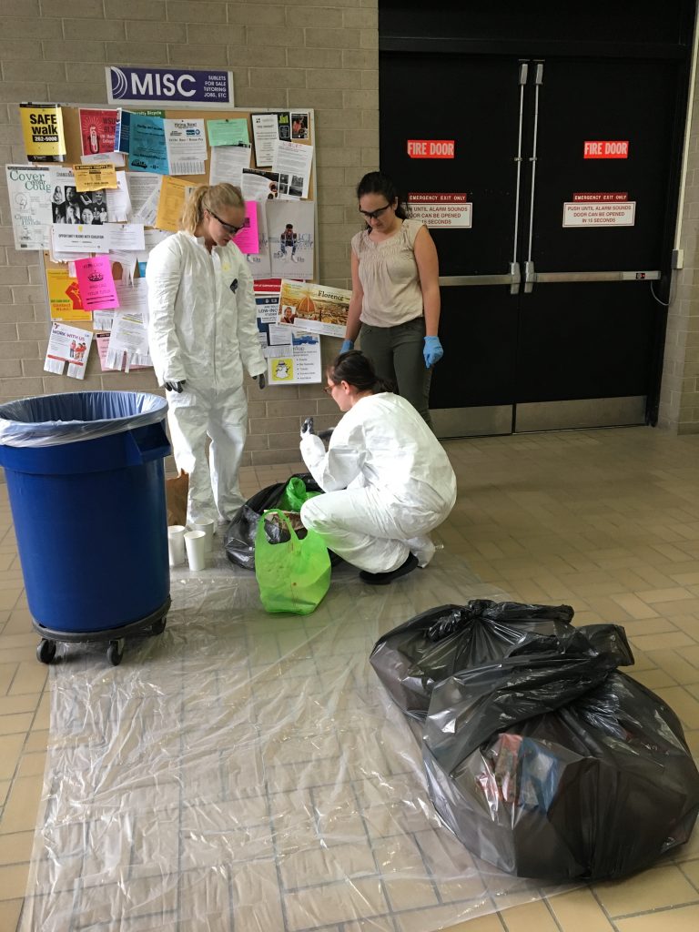 Office of Sustainability interns Meg DiPoto and Jackie Millonzi work with Student Programs Assistant Ally Burg to audit the waste stream at College Library. Photo courtesy of Carrie Kruse.