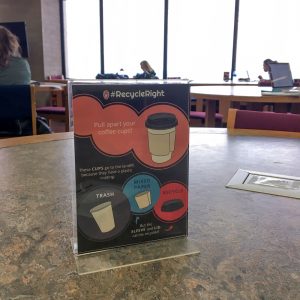 Table tent describing how to pull apart a coffee cup for proper disposal. Image courtesy of Carrie Kruse.