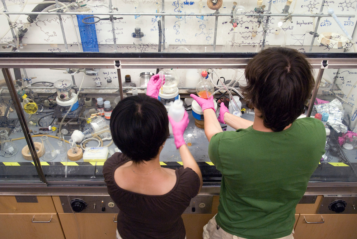 Graduate students Lingyin Li u0028leftu0029 and Ratmir Derda prepare materials under a fume hood in Laura L. Kiesslingu0027s research lab in the Chemistry Building at the University of Wisconsin-Madison
