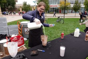 Office of Sustainability intern Ally Magnin prepares a milkshake for an activity at Sustain-a-Bash in 2018.
