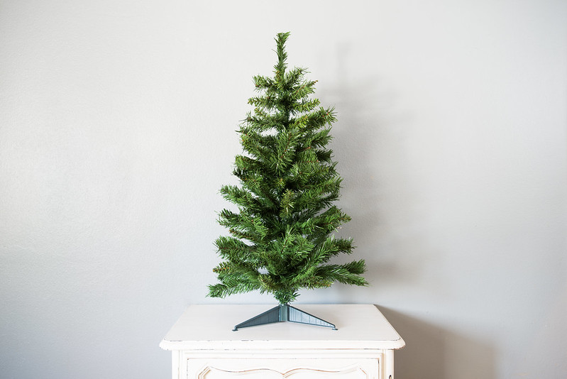 "Small artificial Christmas tree" by Flickr user Your Best Digs.