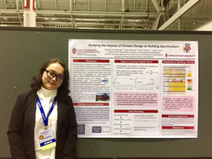 Woman posing next to a poster in a large building
