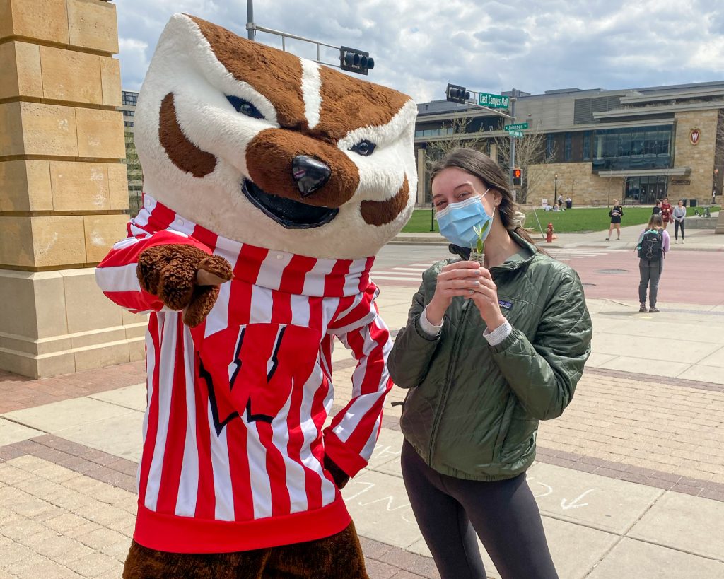 Natalie Tinsen poses with Bucky Badger during the plant giveaway hosted by Allen Centennial Garden, the ASM Sustainability Committee, and the Office of Sustainability. 