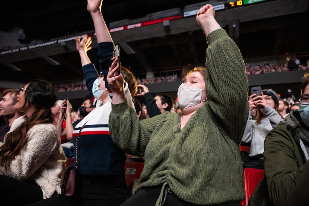 At right, undergraduate super-fan Sydney Kurszewski – who was overhead saying she was more excited to see Bill Nye “The Science Guy” than any concert she’s been to – and her fellow first-year classmate Emily Johnson, at left, cheer as the science educator and television personality takes the stage for Nye’s presentation, “Let’s Talk Climate Change, a Conversation with Bill Nye,” before a student audience of nearly 3,000 at the Kohl Center at the University of Wisconsin–Madison on April 25, 2022. The event, also streamed online, was hosted by the Wisconsin Union Directorate’s (WUD) Distinguished Lecture Series. (Photo by Jeff Miller / UW–Madison)
