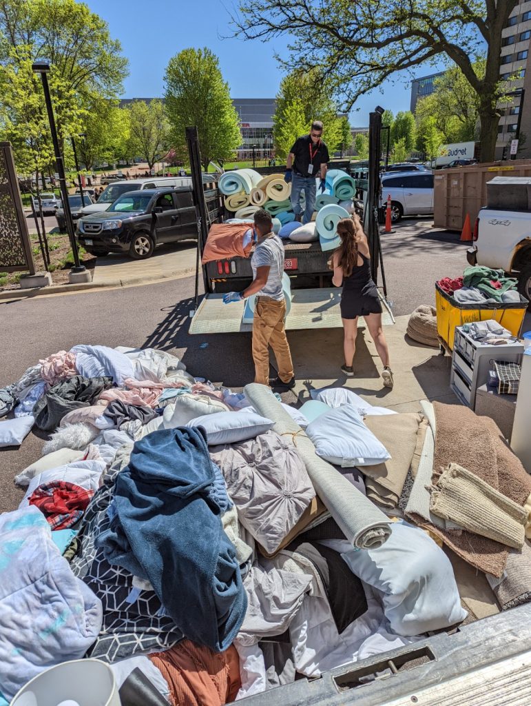 Volunteers help sort discarded materials during move out.