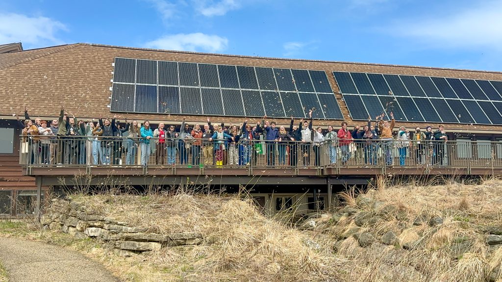 Participants at the EmPOWERing Youth for a Brighter Future event throw celebratory magnolia tepals at the UW Arboretum Visitor Center.