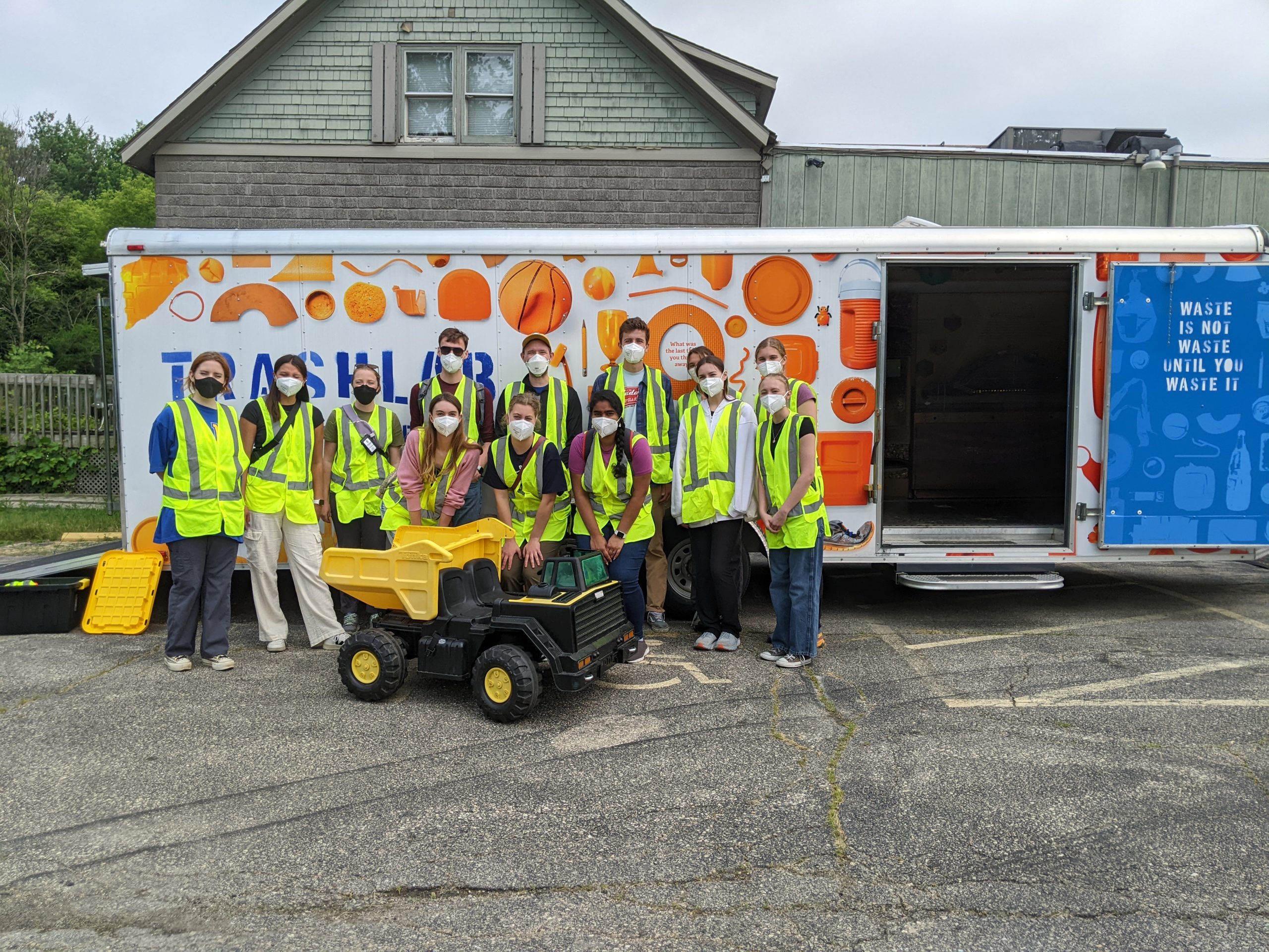 Interns gathered around the Trashlab, a mobile display detailing the work of the Dane County Landfill.