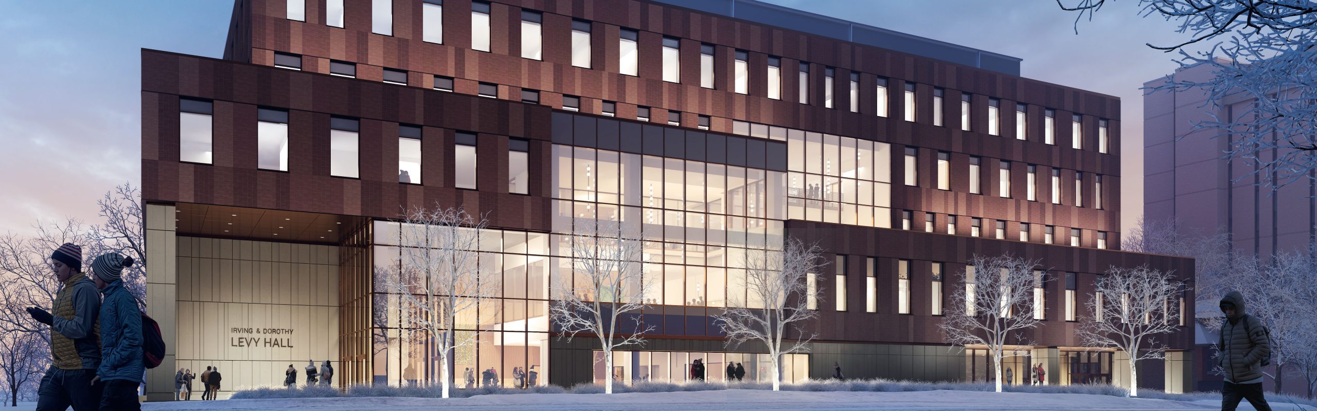 A wide brown five-story building with rows of lit windows