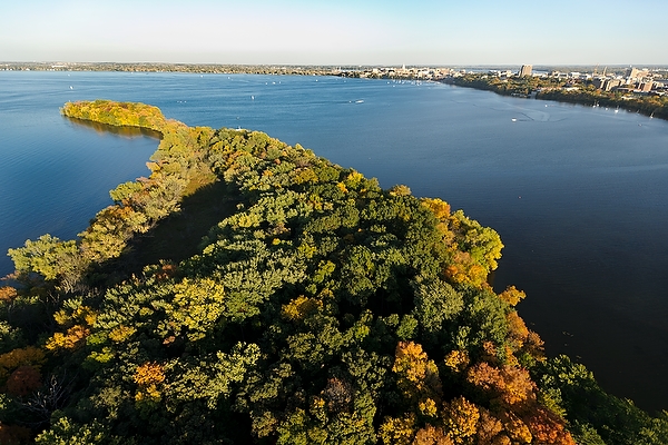 Picnic Point and Lake Mendota are pictured in an aerial view of the University of Wisconsin-Madison campus during an autumn sunset on Oct. 5, 2011. On the horizon is the downtown Madison skyline, right of center, and central UW-Madison campus, at far right. The photograph was made from a helicopter looking southeast. (Photo by Jeff Miller/UW-Madison)