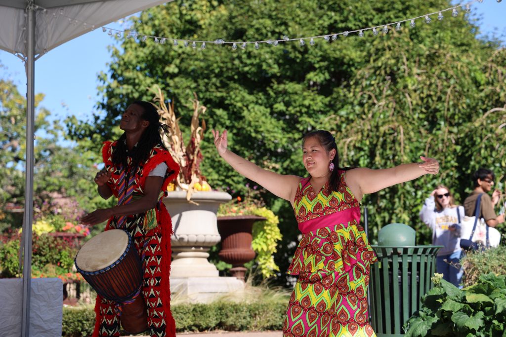 Dancers and a drummer perform in traditional African garb