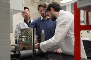 Luca Mastropasqua working with two individuals in a lab. 