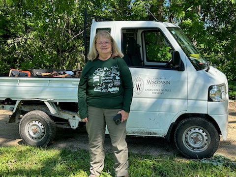 Laura Wyatt standing in front of a white utility vehicle.