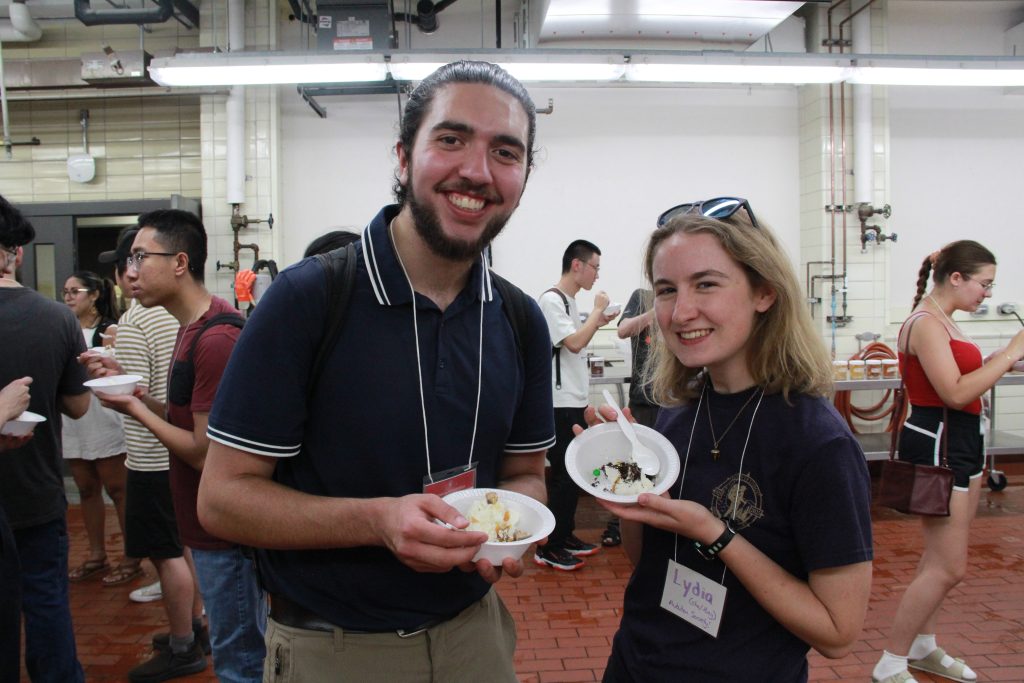 Tour members posing with bowls of ice cream.
