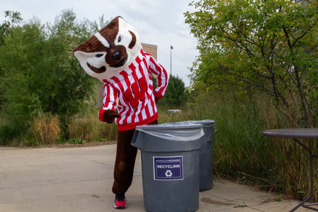 Bucky pointing to the recycling can.