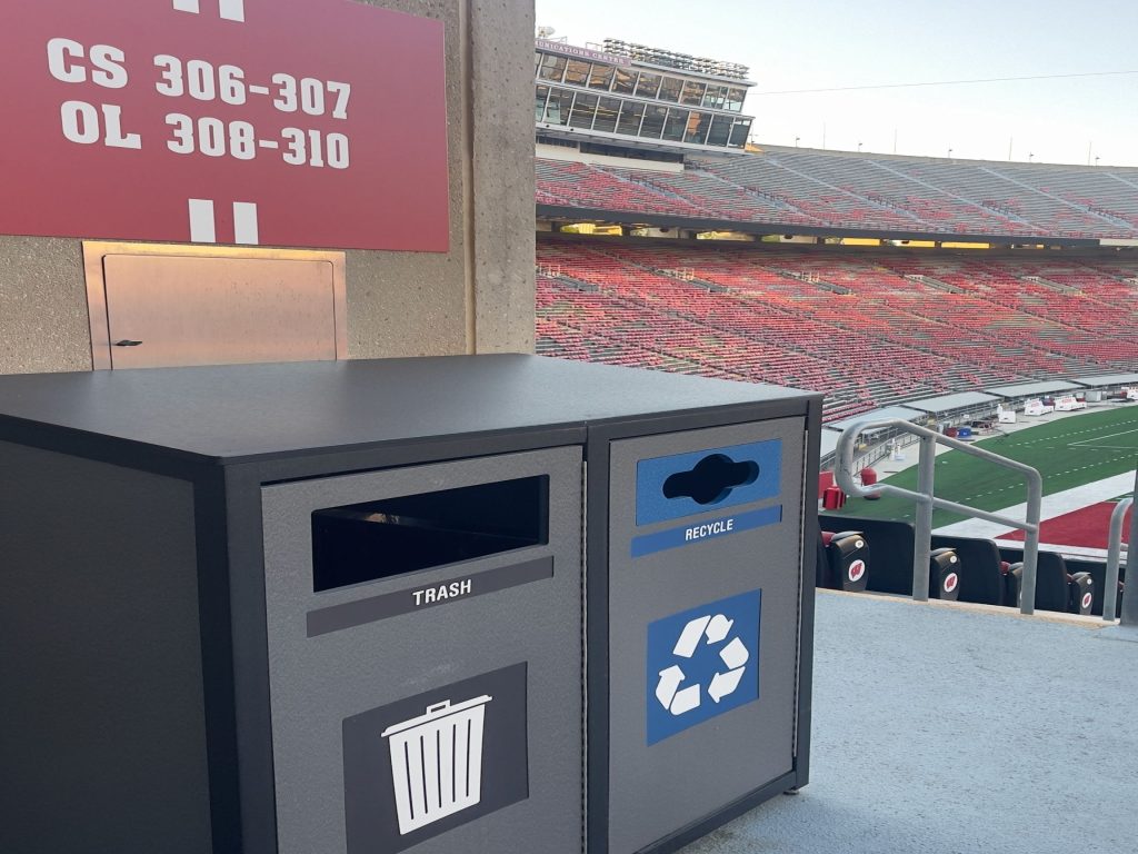 Trash and recycling bins overlooking the field at Camp Randall.