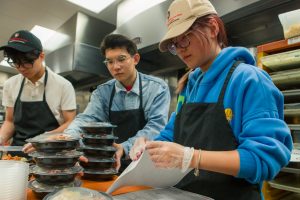Students label packaged meals at Nutrition Access Program headquarters 