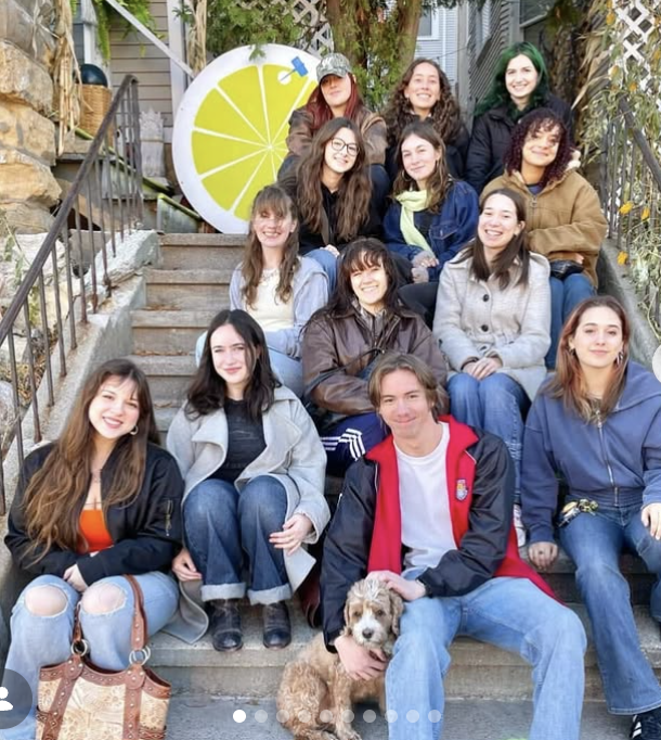 Re-Wear It members (and Redford the dog) enjoy a thrifting crawl in Fall 2025. They are sitting on the steps outside Happy Hours, a Madison thrift store.